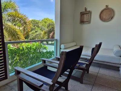 a room with a table and chairs and a window at Oxygen Condominium Bangtao in Ban Thalat Choeng Thale