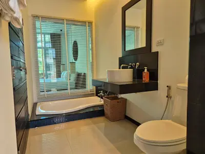 a bathroom with a tub and a sink and a toilet at Oxygen Condominium Bangtao in Ban Thalat Choeng Thale
