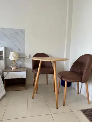 a table and two chairs and a lamp in a room at Apartments Kata Beach view garden in Kata Beach