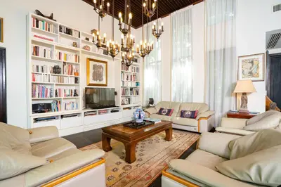 a living room with white furniture and a chandelier at Baan Mandala Villa 4 in Bang Tao Beach