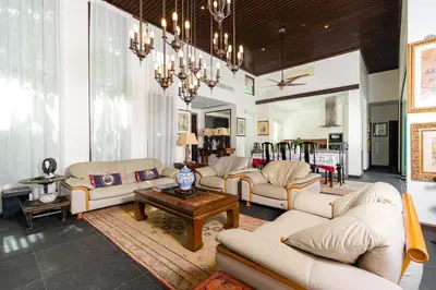 a living room with white furniture and a chandelier at Baan Mandala Villa 4 in Bang Tao Beach