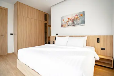a bedroom with a large white bed in a room at Grand Villa Aileen in Nai Yang Beach