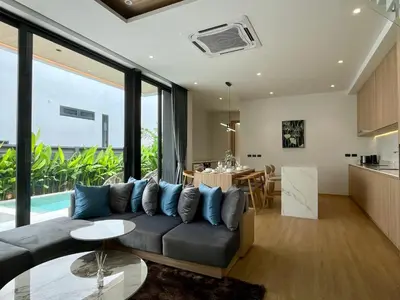 a living room with a couch and a table at Grand Villa Aileen in Nai Yang Beach