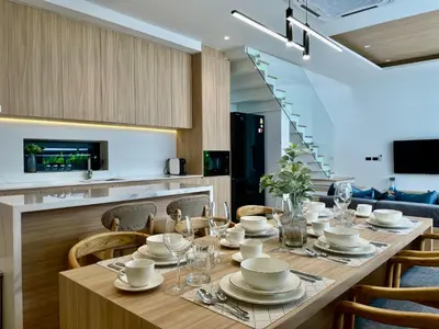 a dining room with a table and chairs at Grand Villa Aileen in Nai Yang Beach