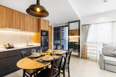 a kitchen and dining room with a table and chairs at Laguna Lakeside BangTao by My Home Phuket in Bang Tao Beach