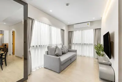 a living room with a couch and a television at Laguna Lakeside BangTao by My Home Phuket in Bang Tao Beach