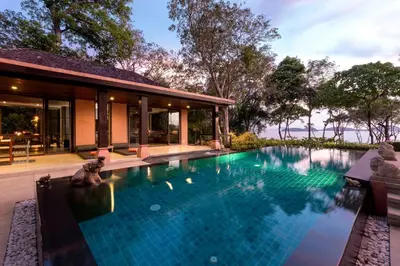 an infinity pool in the backyard of a house at Villa Viva Panwa in Ban Laem Phan Wa