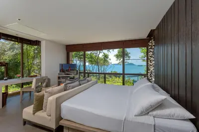 a bedroom with a large bed and a large window at Villa Viva Panwa in Ban Laem Phan Wa