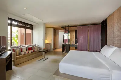 a bedroom with a large bed and a living room at Villa Viva Panwa in Ban Laem Phan Wa