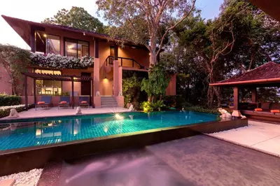 a swimming pool in front of a house at Villa Viva Panwa in Ban Laem Phan Wa