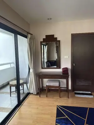 a room with a table and a mirror on the wall at Apartment in Patong Tower in Patong Beach