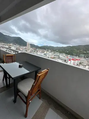 a table and chairs on a balcony with a view at Apartment in Patong Tower in Patong Beach