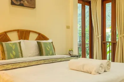 a bedroom with a bed with a wooden headboard at V235 Huge Pool 4 Mins Kamala Beach 12 Mins Patong in Kamala Beach