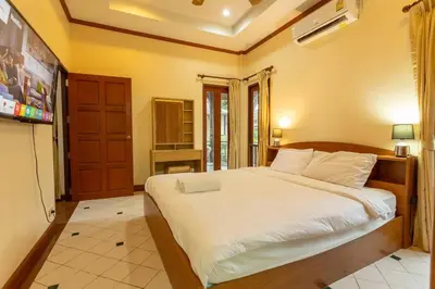 a bedroom with a large bed with white sheets at V235 Huge Pool 4 Mins Kamala Beach 12 Mins Patong in Kamala Beach
