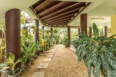 a hallway filled with lots of plants in a building at V235 Huge Pool 4 Mins Kamala Beach 12 Mins Patong in Kamala Beach