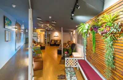 a living room with a wall with plants on it at iDeal Beds Hostel Ao Nang Beach in Ao Nang Beach
