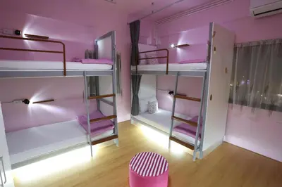a room with pink walls and bunk beds at iDeal Beds Hostel Ao Nang Beach in Ao Nang Beach