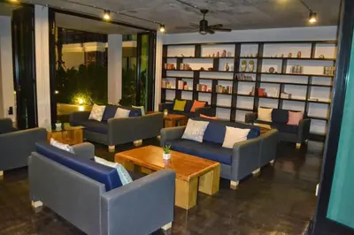 a living room with couches and tables in a room at Renovated apartment in The Title Phase I, Rawai beach in Rawai Beach