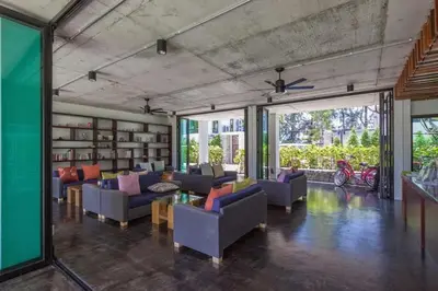 a large living room with couches and tables and windows at Renovated apartment in The Title Phase I, Rawai beach in Rawai Beach