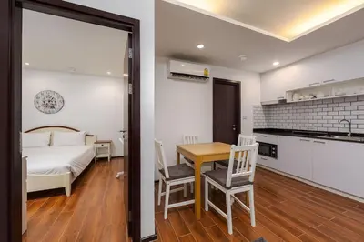 a bedroom with a bed and a table and chairs at Renovated apartment in The Title Phase I, Rawai beach in Rawai Beach