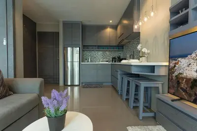 a kitchen and living room with a couch and a table at Best Facilities Fully Loaded Nicest Apartment c138 in Kamala Beach