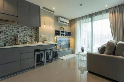 a living room with a couch and a kitchen at Best Facilities Fully Loaded Nicest Apartment c138 in Kamala Beach
