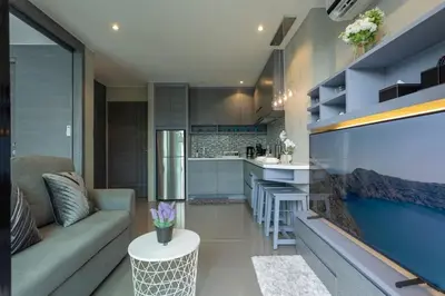 a living room with a couch and a kitchen at Best Facilities Fully Loaded Nicest Apartment c138 in Kamala Beach