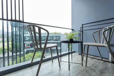 a pair of chairs and a table on a balcony at Best Facilities Fully Loaded Nicest Apartment c138 in Kamala Beach