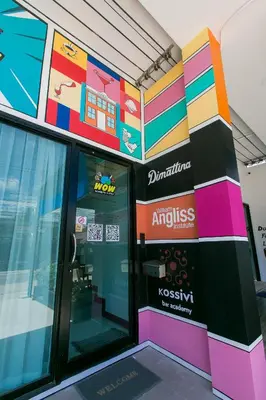 a store front with a colorful wall at Wow Academy & Stay Soi Tai-Aed 2A in Ban Suan