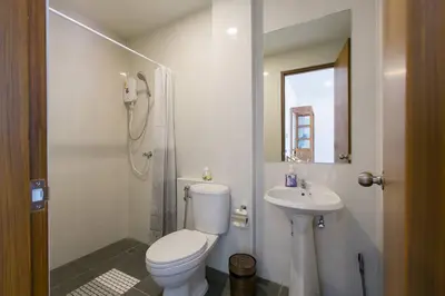 a white bathroom with a toilet and a sink at Wow Academy & Stay Soi Tai-Aed 2A in Ban Suan