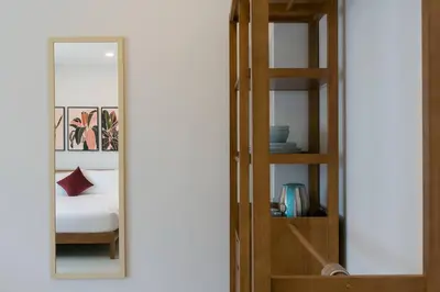 a bedroom with a bunk bed and a mirror at Wow Academy & Stay Soi Tai-Aed 2A in Ban Suan