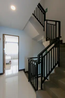 a staircase in a house with a living room at Wow Academy & Stay Soi Tai-Aed 2A in Ban Suan