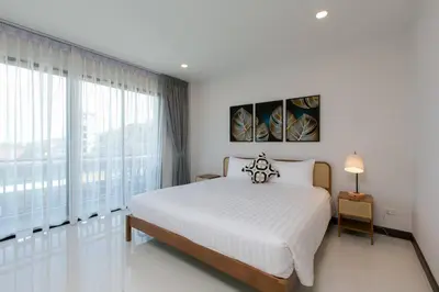 a bedroom with a large bed and a large window at Wow Academy & Stay Soi Tai-Aed 2B in Ban Suan