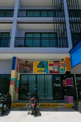 a motorcycle parked in front of a building at Wow Academy & Stay Soi Tai-Aed 3A in Ban Suan