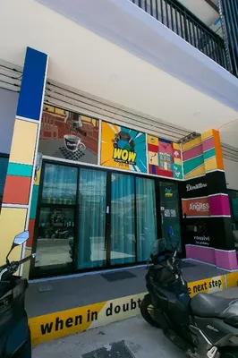 a motorcycle parked in front of a gas station at Wow Academy & Stay Soi Tai-Aed 3A in Ban Suan