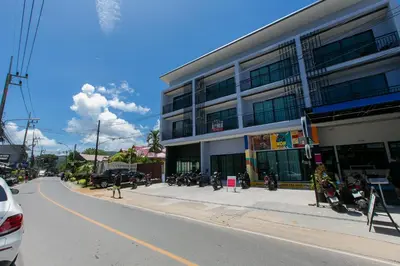 a building with motorcycles parked on the side of a street at Wow Academy & Stay Soi Tai-Aed 3A in Ban Suan