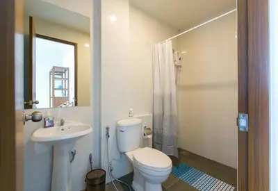 a bathroom with a white toilet and a sink at Wow Academy & Stay Soi Tai-Aed 3A in Ban Suan
