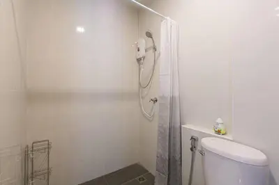 a white bathroom with a shower and a toilet at Wow Academy & Stay Soi Tai-Aed 3B in Ban Suan
