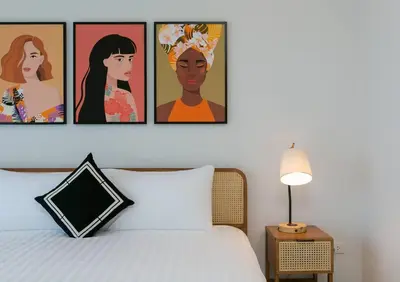 a bedroom with four pictures on the wall above a bed at Wow Academy & Stay Soi Tai-Aed 3B in Ban Suan