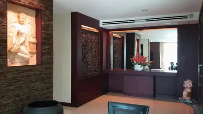 a bathroom with a large mirror and a sink at Karon Suite Apartment in Karon Beach