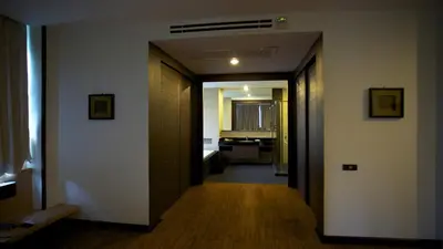 a hallway leading to a room with a bathroom at Karon Suite Apartment in Karon Beach