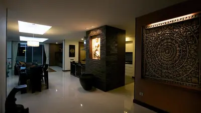 a living room with a large wall art in a house at Karon Suite Apartment in Karon Beach