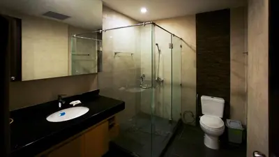 a bathroom with a sink and a shower and a toilet at Karon Suite Apartment in Karon Beach