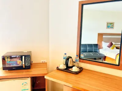 a room with a mirror and a television on a counter at patong v hotel in Patong Beach
