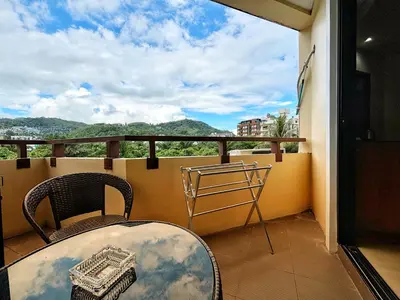 a balcony with a table and chairs and a view at patong v hotel in Patong Beach