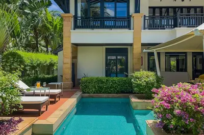 a house with a swimming pool in front of a house at Charming Chom Tawan Villa 3 bdr in Layan Beach
