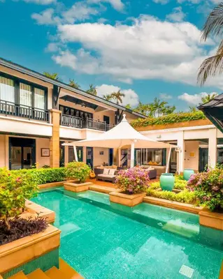 a swimming pool in front of a house at Charming Chom Tawan Villa 3 bdr in Layan Beach