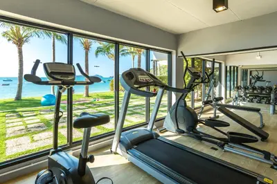a gym with a view of the ocean at Bandara Pool Villas, Phuket in Panwa Beach