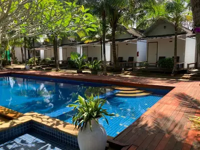a swimming pool in front of a house at Isle Beach Resort Krabi-SHA in Klong Muang Beach