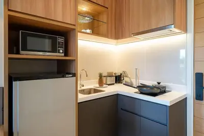 a small kitchen with a sink and a microwave at New 1 br studio in Laguna Phuket in Phuket Town